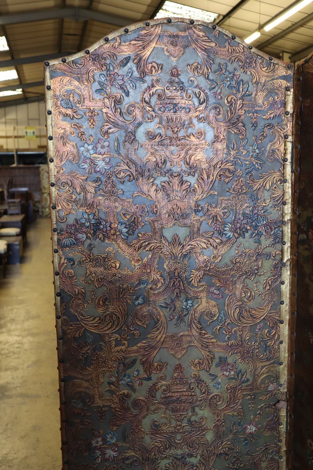 A Spanish embossed leather four-fold screen with painted and gilded leaf, flower and scroll decoration, 198 x 61cm (per panel)